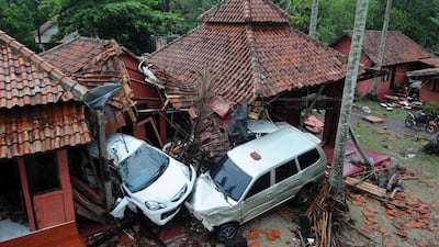 Damaged buildings and cars are seen in Anyer, Serang. AFP