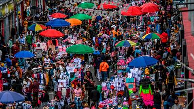 Christmas shoppers roam commercial street in the San Victorino neighbourhood of Bogota, Colombia. AFP