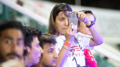 A fan takes shots of the game.