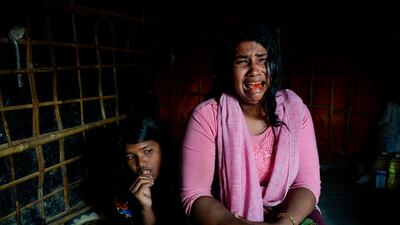 Dildar Begum, a Rohingya widow from Tula Toli village in Myanmar, breaks down in tears next to her daughter Noor Rohima while describing the killings in her village. AFP