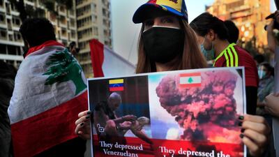 A protester holds a placard, as she marches during a protest against the increase in prices of consumer goods and the crash of the local currency in Beirut on Friday. AP
