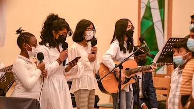 The church choir sing during the service at St Andrew's Abu Dhabi. Khushnum Bhandari / The National