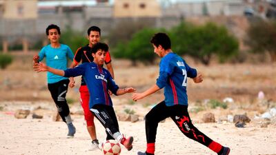 Yemeni youth take part in a football match in their neighbourhood in the capital Sanaa. Mohammed Huwais / AFP