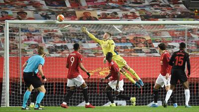 Real Sociedad's Modibo Sagnan watches his header hit the bar as Manchester United's goalkeeper Dean Henderson dives during the Europa League round of 32, second leg. AFP