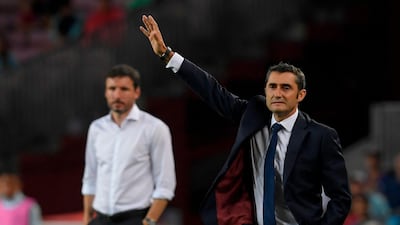 Barcelona's coach Ernesto Valverde gestures next to PSV Eindhoven's coach Mark van Bommel. AFP
