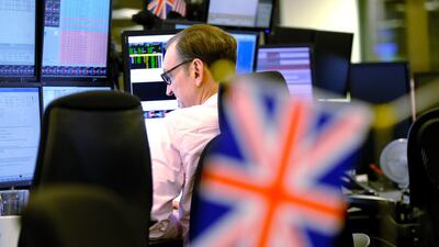 A trader monitors financial data on computer screens as he works on the trading floor at ETX Capital, a broker of contracts-for-difference, after the U.K. general election, in London. The pound initially soared, but then tumbled as much 1.7% following prime minister Boris Johnson’s plans to set a Brexit deadline of December 2020.