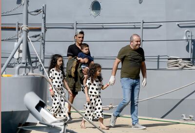 A family disembarks in Malta after being transferred from a humanitarian ship which rescued them at sea more than a week ago, on September 30, 2018. AP