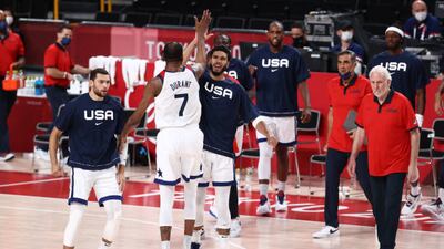 Jayson Tatum of the USA high-fives teammate Kevin Durant.