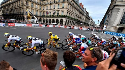 Thomas rides with the pack past the statue of Joan of Arc. AFP