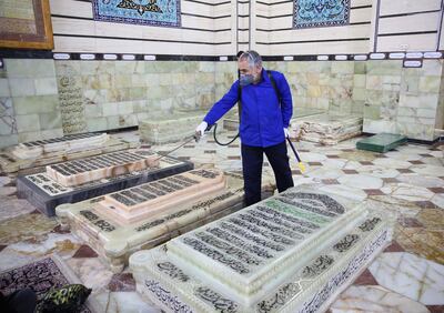 An Iranian sanitary worker disinfects Qom's Masumeh shrine to prevent the spread of Covid-19 in Iran where there are concerns the situation is worse than officially acknowledged. AFP