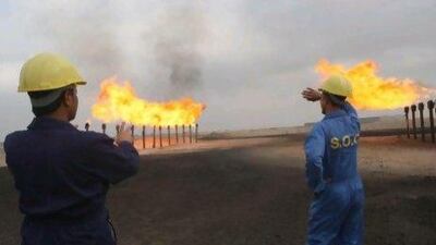 Drake & Scull International's pipeline project for the Zubair oilfield is due for completion by July 2014. Above, engineers watch over flares at the Zubair oilfield. Essam Al Sudani / AFP