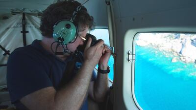 This undated handout photo from the ARC Centre of Excellence for Coral Reef Studies at James Cook University, shows professor Terry Hughes conducting an aerial survey of coral bleaching on the Great Barrier Reef. AFP