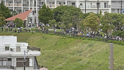 People head for higher ground after a tsunami warning in Naha, Okinawa prefecture, Japan. AP