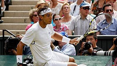Nadal takes a tumble on Centre Court yesterday. His opponent, Novak Djokovic, keeps climbing higher.