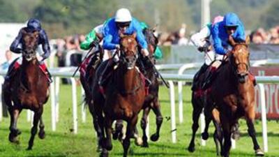Mastery ridden by Ted Durcan, centre, beats Kite Wood piloted by Frankie Dettori, right, to win the St Leger Stakes.