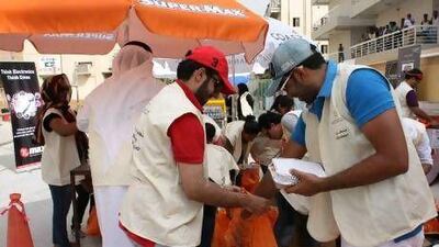 Several of the volunteers packing and distributing the meal bags and toiletry kits are labourers themselves.