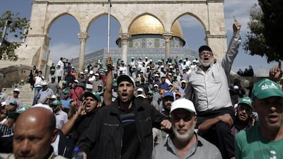 Palestinians demonstrate outside the Dome of Rock at the Al Aqsa Mosque compound, Islam's third-holiest site, on Wednesday. Ahmad Gharabli / AFP