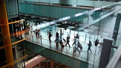 Passengers walk through Terminal 5 of Heathrow Airport in London. Peter Macdiarmid / Getty Images