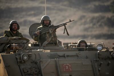 Israeli soldiers aboard an armoured personnel carrier in the Golan Heights near the Israeli border with Lebanon on November 10, 2023 near Kiryat Shmona, Israel. Getty Images