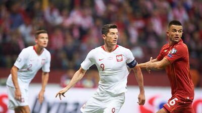 Poland's forward Robert Lewandowski, centre, vies for the ball with North Macedonia's defender Visar Musliu during the Euro 2020 qualifier in Warsaw. AFP