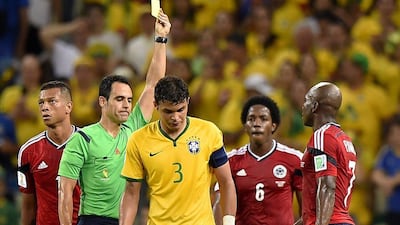 Brazil captain Thiago Silva receives a yellow card in Brazil's quarter-final victory over Colombia at the 2014 World Cup on July 4, 2014. Fabrice Coffrini / AFP