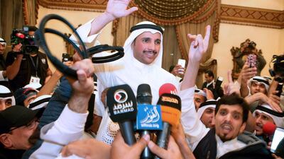 Kuwaiti candidate and former parliament speaker Marzouq Al Ghanem (C) celebrates with his supporters in Kuwait City following the announcment of his victory in the parliamentary election early on November 27, 2016. Yasser Al Zayyat/AFP