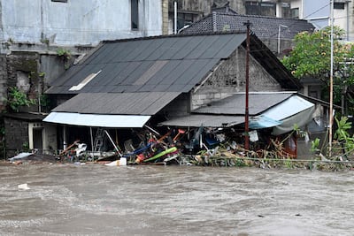 A house is inundated by floodwaters in Denpasar. AFP