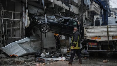 Workers in Aleppo remove damaged cars following clashes between Kurdish-led Syrian Democratic Forces (SDF) and Syrian government troops. EPA
