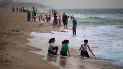 Palestinian families wait to have their Iftar breaking a Ramadan fasting day on the beach of Gaza City. AP Photo