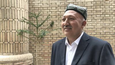 Abbol Hassan Tursoniyez, the khatib of Hotan Kamai Mosque, stands by the mosque gate.