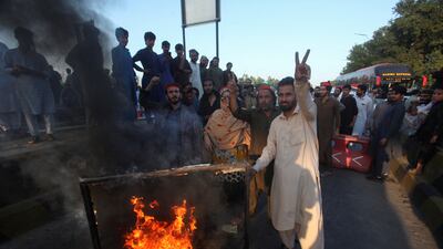 Protesters chant slogans as they block the main highway in Peshawar. Reuters