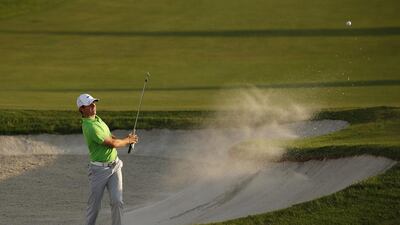 Northern Ireland’s Rory McIlroy gave the gallery something to cheer about with his shot out of the bunker at the 18th, which he rolled into the hole for a birdie to leave him tied for sixth at 4-under. Paul Childs / Reuters