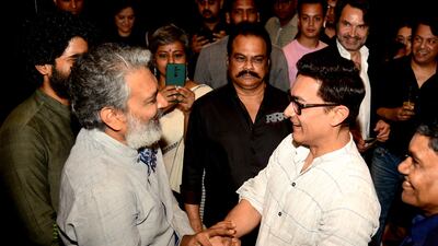 Bollywood actor Aamir Khan, right, attends an event to celebrate the box-office success of RRR in April 2022. AFP