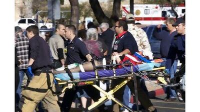 Medical workers transport a victim from the site of the attack on Saturday outside a shopping centre in Tucson, Arizona. James Palka / AP Photo