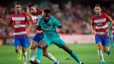Granada's Spanish midfielder Antonio Puertas vies with Barcelona's Guinea-Bissau forward Ansu Fati. EPA