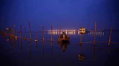 A boatman waits for devotees at Sangam, the confluence of the rivers Ganges and Yamuna during the annual traditional fair, Magh Mela, in Allahabad. Rajesh Kumar Singh / AP Photo