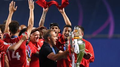 Bayern Munich coach Hansi Flick holds the trophy. Reuters