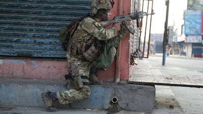 An Afghan security official takes position near the scene of a militant attack on prison in Jalalabad, Afghanistan. EPA