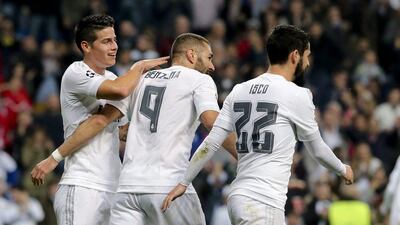 Real Madrid’s James Rodriguez and Isco congratulate teammate Karim Benzema after his second goal to make it 2-0 against Malmo on Tuesday. Ballesteros / EPA