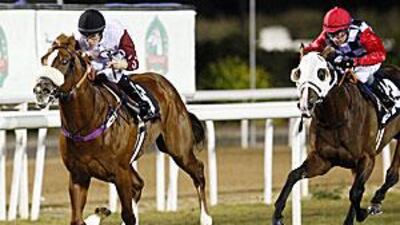 Montmorency, ridden by Richard Mullen, comes in to win the Ashgabat Gold Trophy ahead of Dan Chillingworth at the Abu Dhabi Equestrian Club last night.