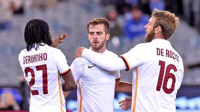 AS Roma's Miralem Pjanic, centre, celebrates with teammates Gervinho, left, and Daniele De Rossi, right, after scoring an equaliser on Tuesday against Manchester City in a pre-season match. Joe Castro / EPA
