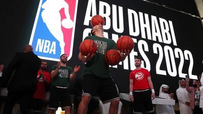 A freestyle performer balances basketballs during the press conference for the NBA Abu Dhabi Games.