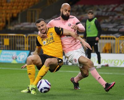 Romain Saiss of Wolverhampton Wanderers and David McGoldrick of Sheffield United during the Premier League match this month. Getty Images