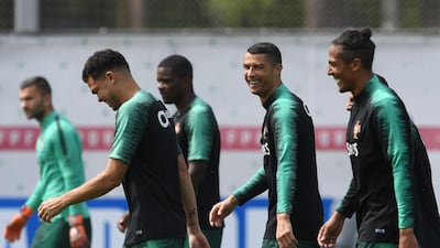 Cristiano Ronaldo, second right, laughs with teammates during a training session at their base camp in Kratovo, Moscow, Russia, on June 12, 2018. Francisco Leong / AFP