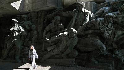 A woman walks past the Second World War open-air museum in Kyiv a day before the Independence Day of Ukraine, amid the Russian invasion in Ukraine. AFP