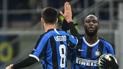 Inter Milan's Belgian forward Romelu Lukaku (R) celebrates with midfielder Matias Vecino after levelling. AFP