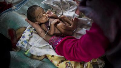 Pediatric nurse Isabelle Arnould examines a baby in the neonatal ward at the MSF Maternity Hospital in Khost, Afghanistan. Andrea Bruce/ Noor Images