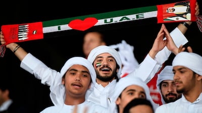 An Emirati supporter waves a scarf during the 2019 AFC Asian Cup group A football match between India and UAE at Zayed Sports City stadium in Abu Dhabi. AFP