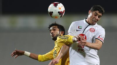 Al Jazira, in white, took advantage of league leaders' Al Ahli's draw against Al Wahda on Friday by beating Al Wasl to draw closer to the top of the Arabian Gulf League standings. Afsal Sham / Al Ittihad