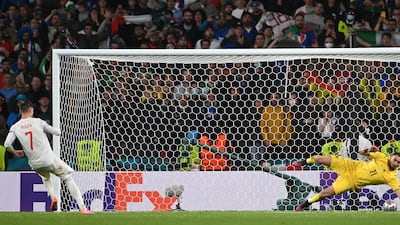 Italy's goalkeeper Gianluigi Donnarumma saves Alvaro Morata's penalty.